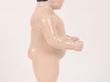 a small plastic toy of a baby standing on a white surface