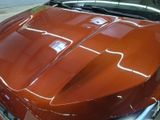 a close up of a car with a shiny hood