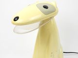 a yellow lamp that is sitting on a table