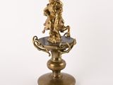 a gold statue of a man riding a horse on a pedestal