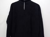 a close up of a black sweater hanging on a hanger