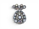 a close up of a brooch on a white background