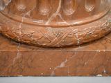 a close up of a marble pedestal with a clock on it