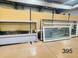 two glass display cases in a warehouse with yellow walls