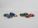 two small toy cars are sitting side by side on a white surface