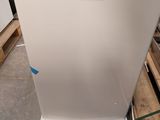 an image of a white refrigerator in a warehouse