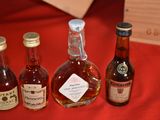 several bottles of liquor are lined up on a red table