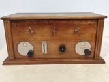 an old wooden radio sitting on top of a white table