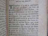 an old book that is open on a table