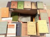 many books stacked on top of each other on a table