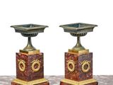 pair of antique bronze and marble candlesticks on a marble table