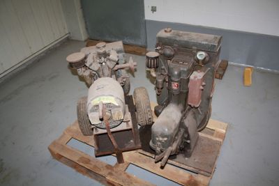 two engines sitting on a pallet in a room