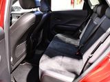 a red car with a black seat cover in the back of it