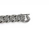 an image of a close up of a chain bracelet on a white surface