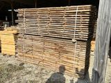 a large pile of wood sitting in the middle of a field