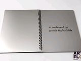 a notebook with writing on it sitting on a table