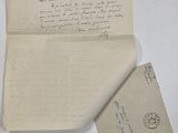 a close up of a piece of paper with a letter on it