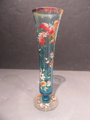 a glass vase with a floral design on it