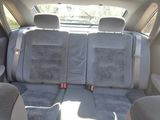 the back seats of a car are covered in gray cloth