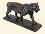 statue en bronze représentant un tigre, posée sur un socle en marbre, sur fond blanc