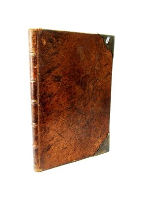 an old book with a brown cover on a white background