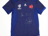 a close up of a blue shirt with a red rooster on it
