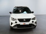 the front view of a white car parked in a showroom