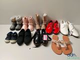 several pairs of shoes are lined up on a white surface
