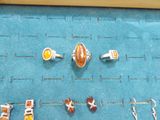 many different rings and earrings displayed on a blue mat