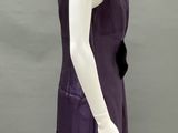 a mannequin wearing a purple dress on a mannequin stand