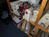 many sewing machines on a shelf in a room