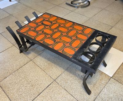 a coffee table that has been painted orange and black