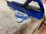 a clamp that is sitting on top of a piece of wood