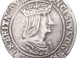 a close up of a silver coin with a crown on it
