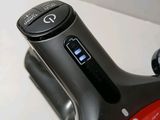 a close up of a bicycle with a red handlebar