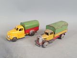 two toy trucks sitting next to each other on a table