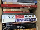 many books in a cardboard box on a table