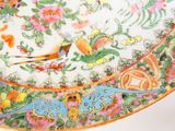 a colorful plate with a bird on it on a table