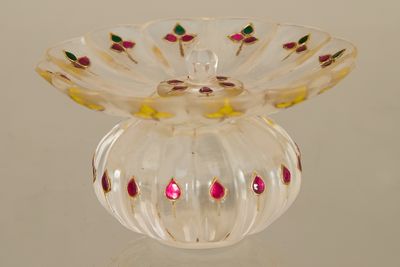 a glass vase with a pink flower inside of it