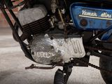 a close up of a blue motorcycle parked on the street
