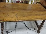 a wooden table that is sitting on a tile floor