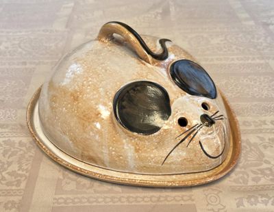 a cat shaped dish on a table with a cat ' s face painted on it