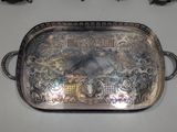 a silver tray with a bird on it on a table