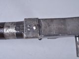 a close up of a gun with a metal handle
