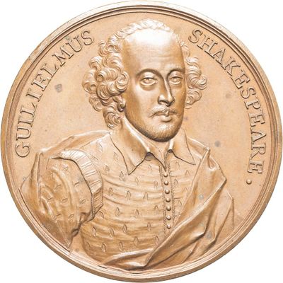 an image of a gold medal with a portrait of a man on it
