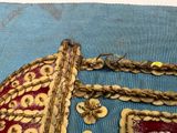a close up of a piece of cloth with gold decorations on it