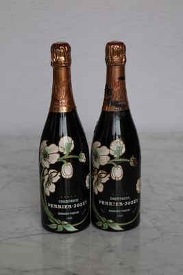 two bottles of wine sitting on a marble table