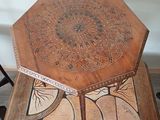 a wooden table with a decorative design on it