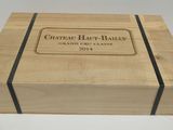 a wooden box with a label that says chateau haut - bailey grand cru classe 2014
