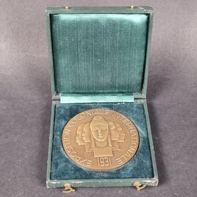 an image of a gold medal in a green case